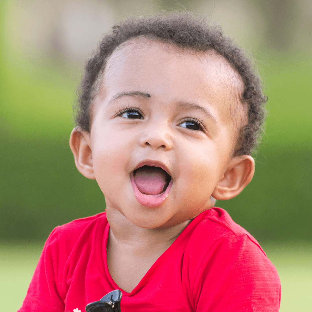 Close-up of a laughing baby outdoors