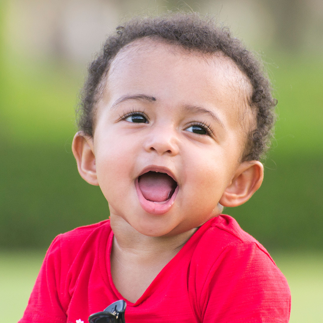 Close-up of a laughing baby outdoors